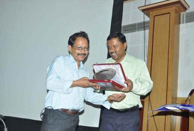 Coordinator presenting the token of appreciation to Mr. Uddhab Bharali